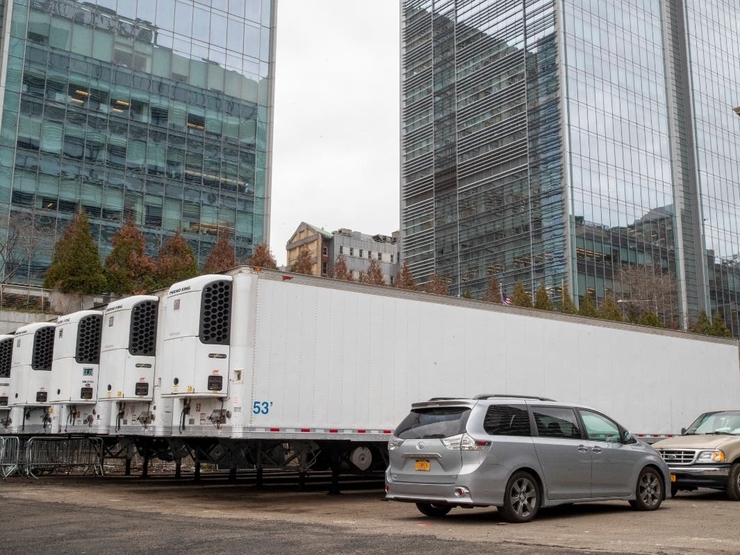 Refrigerated trailers are seen parked at the site of a makeshift morgue being built in New York on Wednesday.