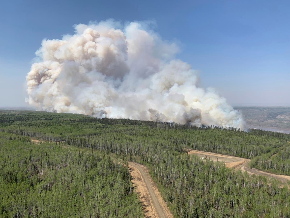 In addition to the rain on Friday, Chicago area residents may see some hazy, smoky skies, due to wildfire smoke from Canada. Pictured: a wildfire burns a section of forest in the Grande Prairie district of Alberta, Canada last weekend.