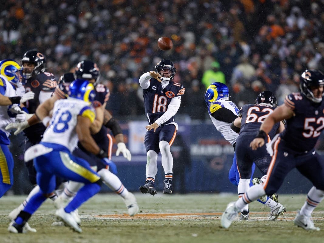 Chicago Bears quarterback Caleb Williams (18) passes the ball against the Los Angeles Rams during the first half of an NFL divisional playoff football game on Sunday.