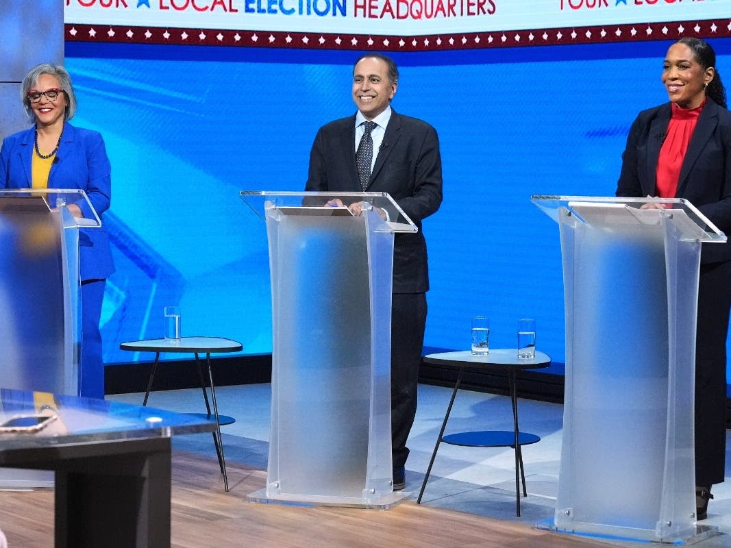 U.S. Rep. Robin Kelly (D-Ill.), left, U.S. Rep. Raja Krishnamoorthi (D-Ill.), center, and Illinois Lt. Gov. Juliana Stratton (D), smile as they wait for U.S. senate Democratic Primary Debate in Chicago.
