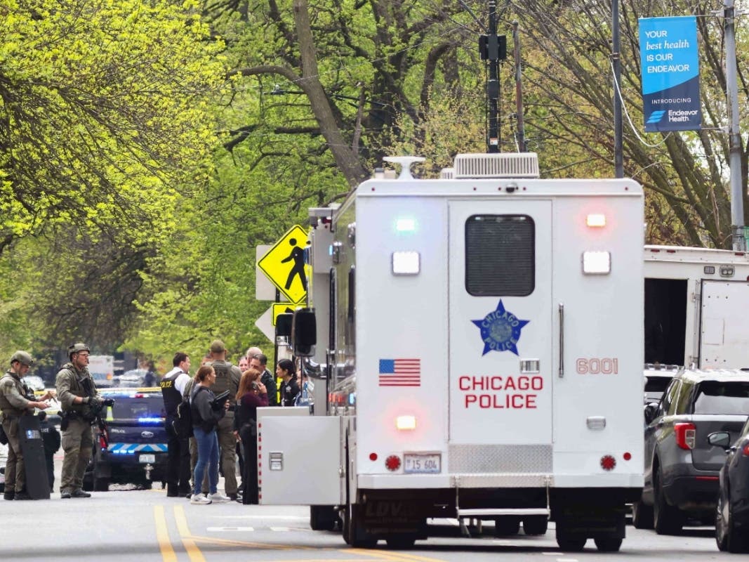 Police officers work the scene outside Endeavor Health Swedish Hospital in Lincoln Square on Saturday. One officer was killed, and another was fighting for their life after being shot by a suspect, officials said.