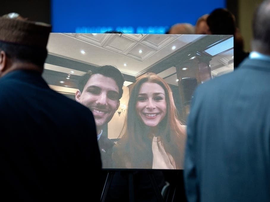Visitors walk past a photo of slain Israeli Embassy staff members Yaron Lischinsky, left, and Sarah Milgrim, right, before a service to mark the reopening of the Capital Jewish Museum after the two were killed following an event at the museum in 2025. 