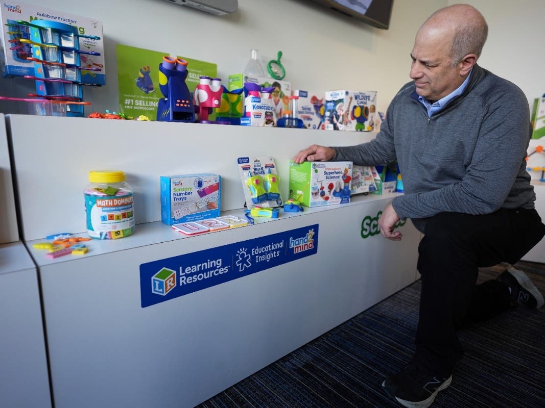 Rick Woldenberg, CEO of Learning Resources, an educational toy company, looks at products at a showroom in Vernon Hills. The company is once again challenging Trump tariffs after winning a similar lawsuit earlier this year.