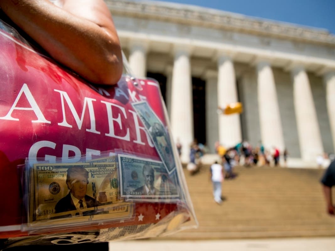 A woman carries campaign materials to the Lincoln Memorial for President Trump's "Salute to America" event.
