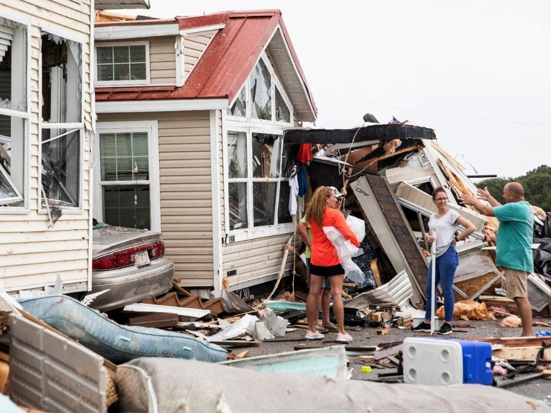 Residents of the Boardwalk RV Park discuss the path of a possible waterspout or tornado, generated by Hurricane Dorian, that struck the are in Emerald Isle, North Carolina Thursday, Sept. 5, 2019.