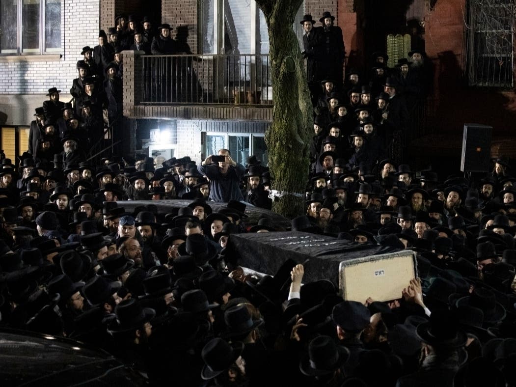 Orthodox Jewish men carry Moshe Deutsch's casket outside a Brooklyn synagogue following his funeral in New York. Deutsch, who was killed at a kosher food market in New Jersey. Authorities say the attack was motivated by hatred of Jewish people and police.