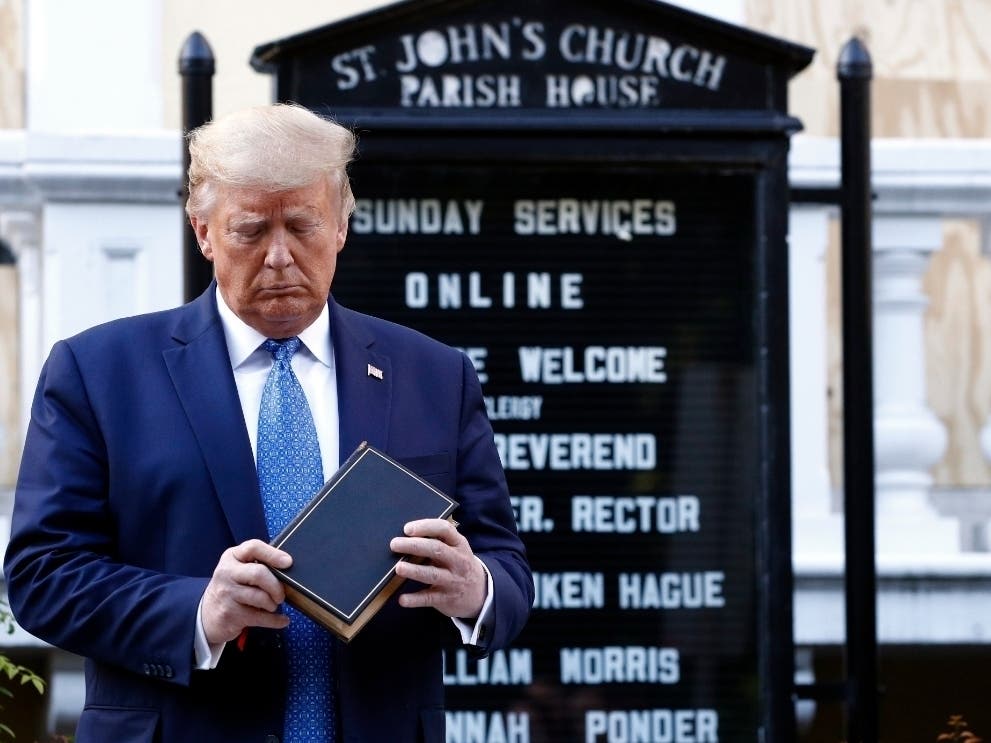President Donald Trump holds a Bible during a visit Monday outside St. John's Church across Lafayette Park from the White House after armored military police cleared the area with flash bombs and tear gas.