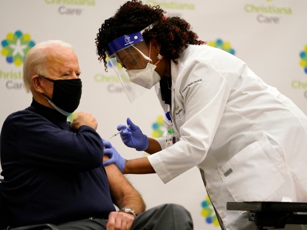 President-elect Joe Biden receives his first dose of the coronavirus vaccine from nurse practitioner Tabe Mase Monday at a Newark, Delaware, hospital. Biden got the shot on live television to send a message of confidence in the vaccine to Americans.