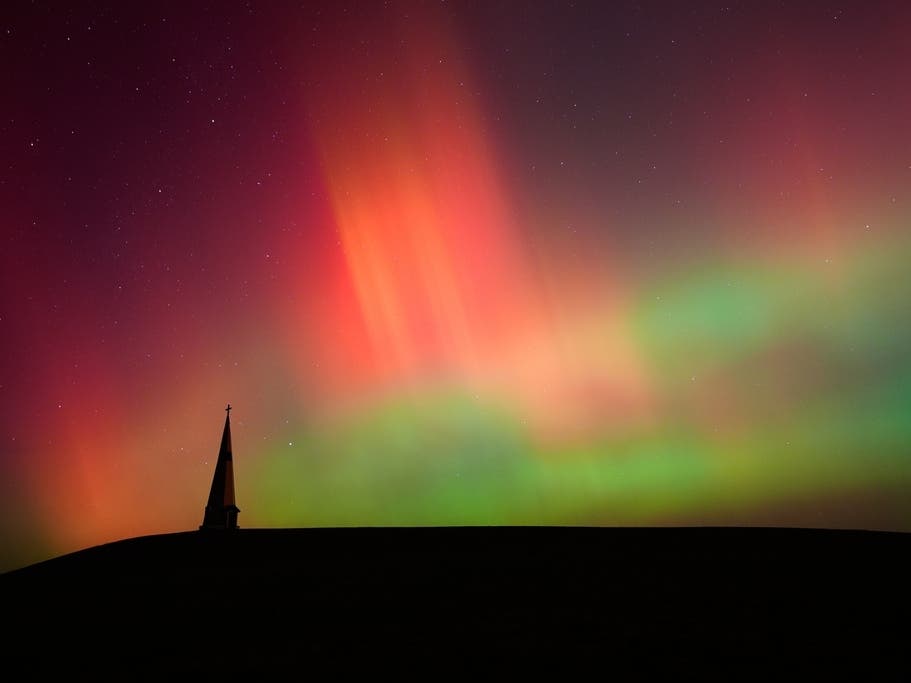 The northern lights fill the sky behind the Saint Joseph the Woodworker Shrine near Valley Falls, Kansas, on Nov. 11, 2025.