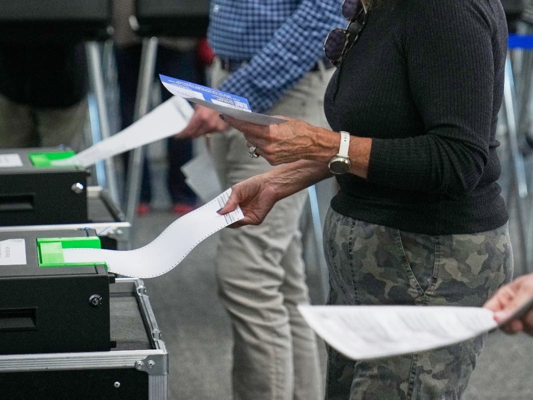 Voters enter their ballots into scanners at early in-person voting in Cleveland on Oct. 7. Some 43 million Americans have already voted in the midterms, which will decide control of Congress.