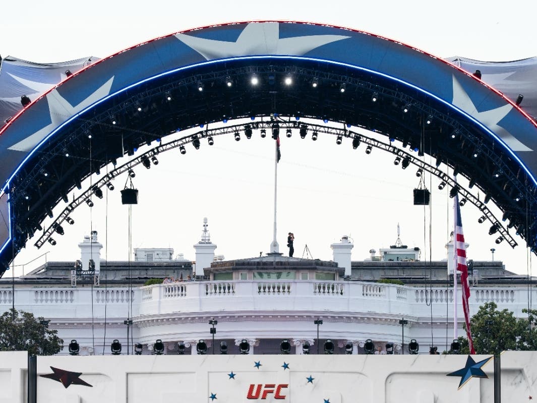 Security at the White House looks through a pair of binoculars during the UFC Fan Fest on the White House Ellipse ahead of Sunday's fight on the South Lawn, June 13, 2026, in Washington.