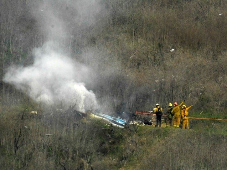 Firefighters work the scene of a helicopter crash where former NBA star Kobe Bryant died, Sunday, Jan. 26, 2020, in Calabasas, Calif.