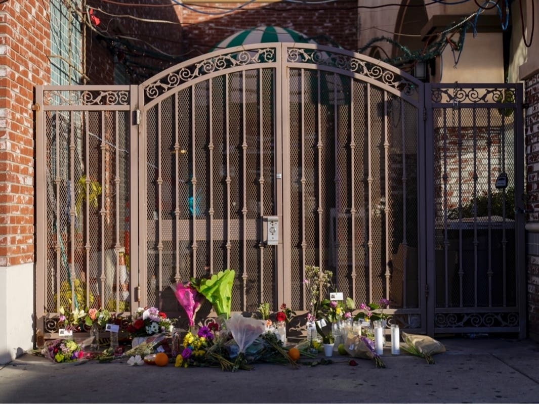 Flowers are placed at the entrance to Star Dance Studio in Monterey Park, Calif., Monday, Jan. 23, 2023.