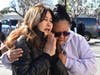 A woman, left, who knew Yu Kao, one of the victims, is consoled in front of a makeshift memorial in front of the Star Ballroom Dance Studio in Monterey Park, Calif., Tuesday, Jan. 24, 2023.
