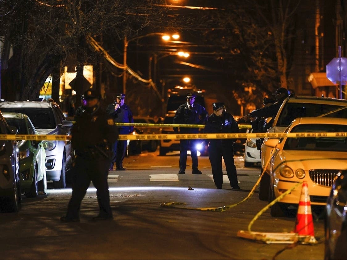 Philadelphia police officers investigate the fatal shooting of a Temple University police officer near the campus on Saturday, Feb. 18, 2023, in Philadelphia.
