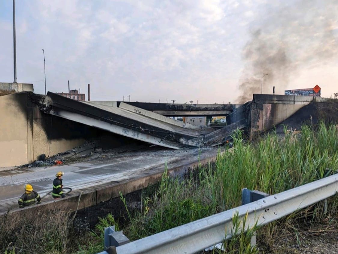 This image provided by the Philadelphia Fire Department shows firefighters standing near the collapsed part of Interstate 95 in Philadelphia, Sunday, June 11, 2023.