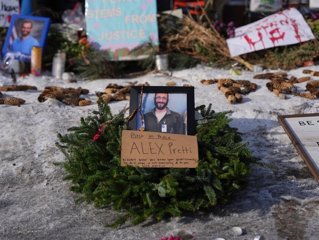 A makeshift memorial is placed where Alex Pretti was fatally shot by a U.S. Border Patrol officer yesterday, in Minneapolis, Sunday, Jan. 25, 2026.
