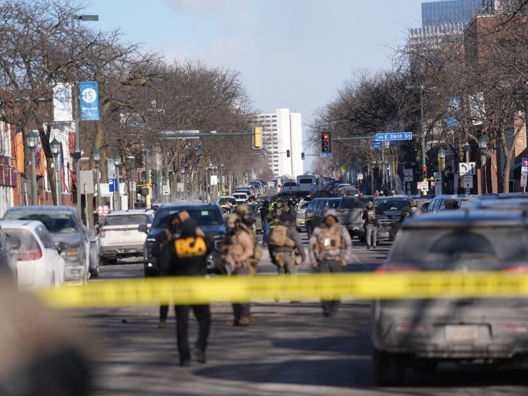 Federal agents stand near the site of a shooting Saturday, Jan. 24, 2026, in Minneapolis.