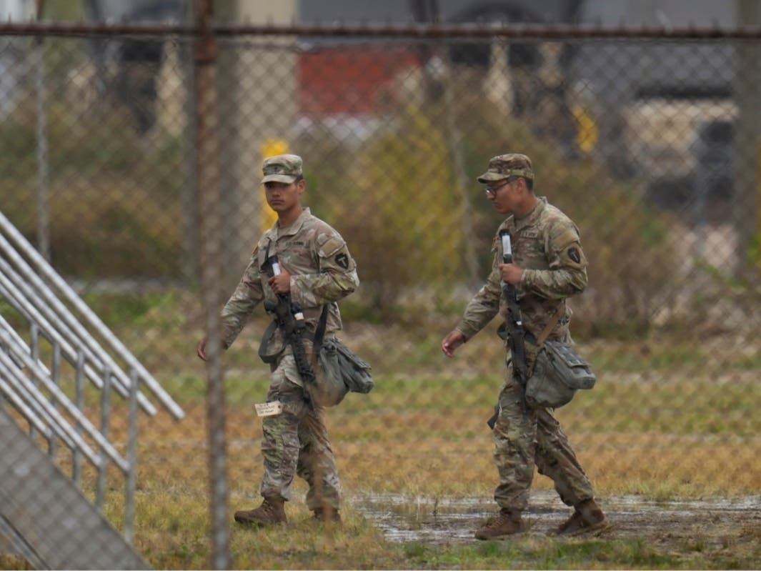 Military personnel in uniform, with the Texas National Guard patch on, are seen at the U.S. Army Reserve Center, Tuesday, Oct. 7, 2025, in Elwood, Ill., a suburb of Chicago.