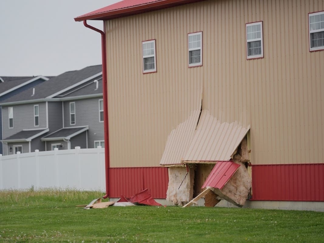 Damage is visible at the scene after a car barreled through a building used for an after-school camp, April 29, 2025, in Chatham, Ill.
