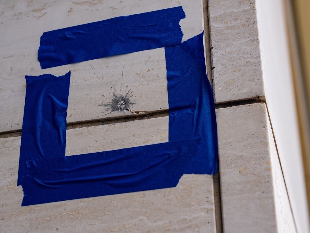 Blue tape is pictured around a possible bullet strike near the scene of a shooting close to the White House, Sunday, May 24, 2026, in Washington.