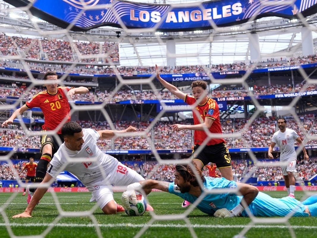 Iran goalkeeper Alireza Beiranvand (1) makes a save from Belgium's Maxim De Cuyper (5) during the World Cup Group G soccer match between Belgium and Iran in Inglewood, Calif., near Los Angeles, Sunday, June 21, 2026.