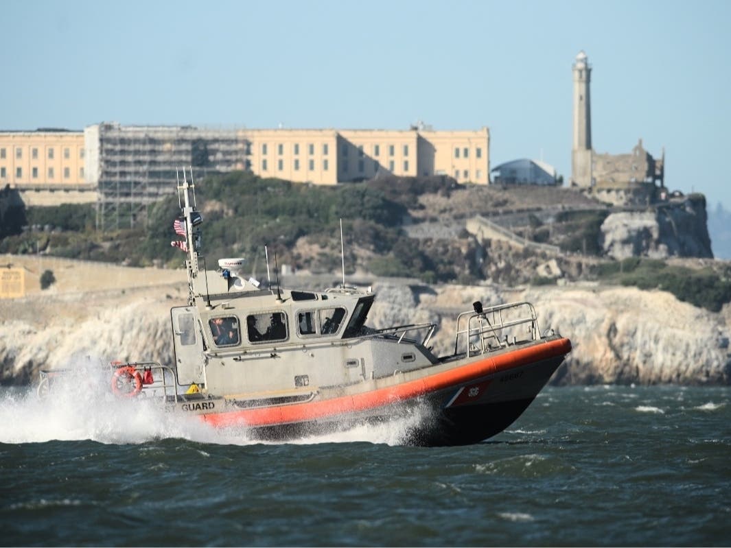 A U.S. Coast Guard crew goes past Alcatraz Island near the site of a pontoon boat accident on Tuesday, July 14, 2026, in San Francisco.