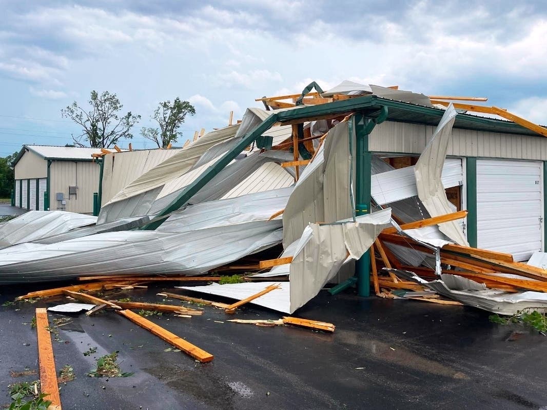 In this photo provided by Christian Jensen, twisted metal and wooden planks from a building damaged by a severe storm litter the pavement, Monday, July 27, 2026, in Menasha, Wis.