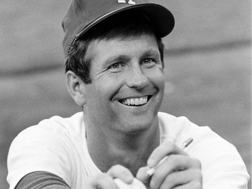 Lefthander Tommy John of the Los Angeles Dodgers signs an autograph before a game, Aug. 12, 1977.