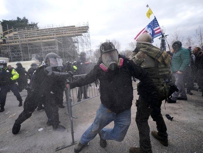 Trump supporters try to break through a police barrier, Wednesday at the Capitol in Washington. As Congress prepares to affirm President-elect Joe Biden's victory, thousands of people have gathered to show their support for President Donald Trump.