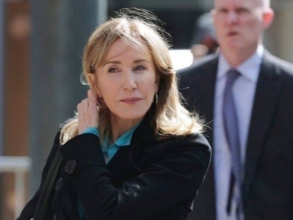 Actress Felicity Huffman reported to Dublin's federal prison Tuesday to begin a two-week sentence stemming from her guilty plea last month in a college admissions cheating scandal.