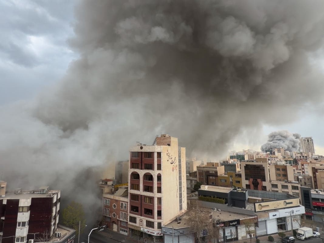 Plumes of smoke from two simultaneous strikes rise over Tehran, Iran, Monday, March 2, 2026. 