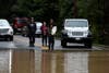 Residents look at a flooded section of state Highway 116, Wednesday, Feb. 27, 2019 in Guerneville, California.