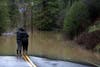 Ari Herman and Lea Herman embrace as they look at a flooded section of Highway 116 on Feb. 27, 2019 in Guerneville, CA.