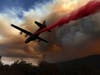 A Modular Airborne Fire Fighting Systems (MAFFS) equipped C-130 aircraft drops retardant ahead of the LNU Lightning Complex fire on August 20, 2020 in Healdsburg, California. 