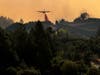 A firefighting aircraft drops retardant ahead of the LNU Lightning Complex fire on August 20, 2020 in Healdsburg, California. The LNU Lightning Complex fire is spread over five counties.