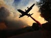 A firefighting aircraft drops retardant ahead of the LNU Lightning Complex fire Thursday, Aug. 20, 2020, in Healdsburg, California. 