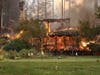 The main building and restaurant at Meadowood Napa Valley luxury resort burns Monday after the Glass Incident Fire moved through the area in St. Helena.