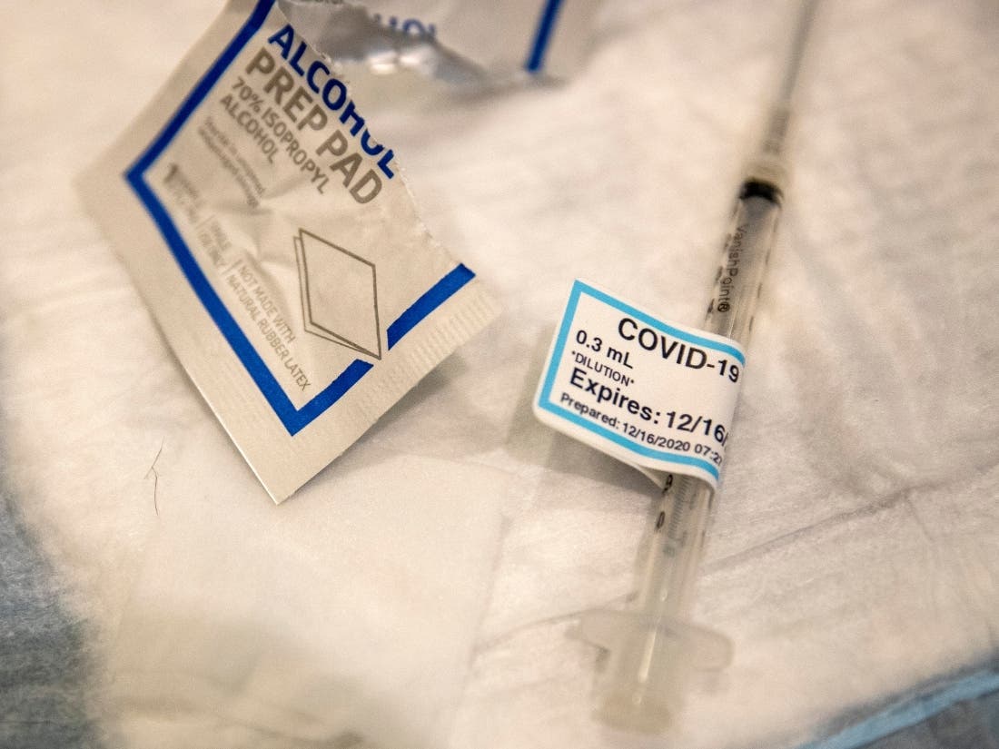 An empty syringe lies on a table at Ronald Reagan UCLA Medical Center after a care worker received the COVID-19 vaccine Wednesday in Westwood, California.