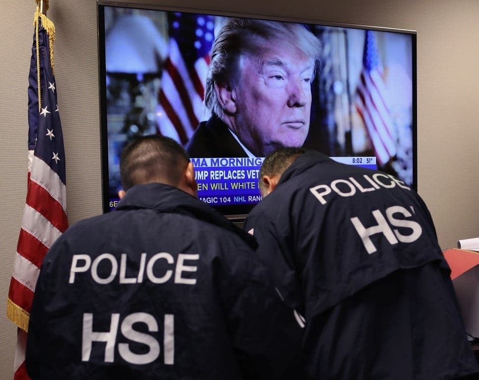 Homeland Security Investigations (HSI) ICE agents work in a control center during an operation targeting immigrant gangs in Central Islip, New York.