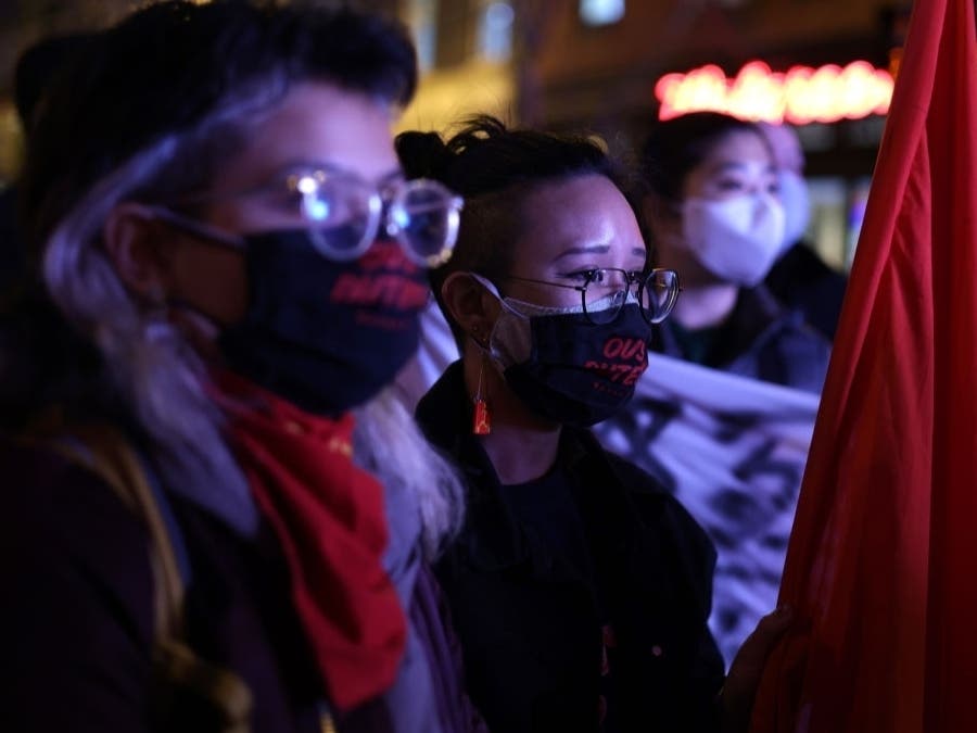 Activists participate in a vigil in response to the Atlanta spa shootings March 17, 2021 in the Chinatown area of Washington, DC.