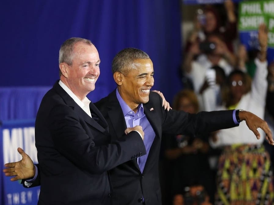 Former U.S. President Barack Obama stands on stage with Gov. Phil Murphy during an event in Newark, New Jersey in October 2017.