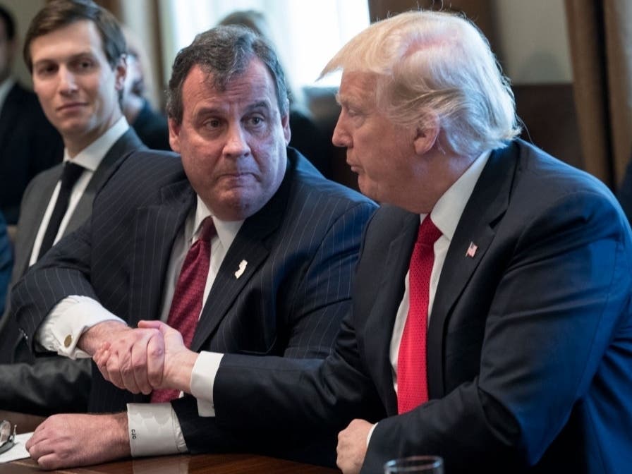 Former president Donald Trump shakes hands with former New Jersey Gov. Chris Christie at a panel discussion on an opioid and drug abuse in the Roosevelt Room of the White House on March 29, 2017 in Washington D.C.