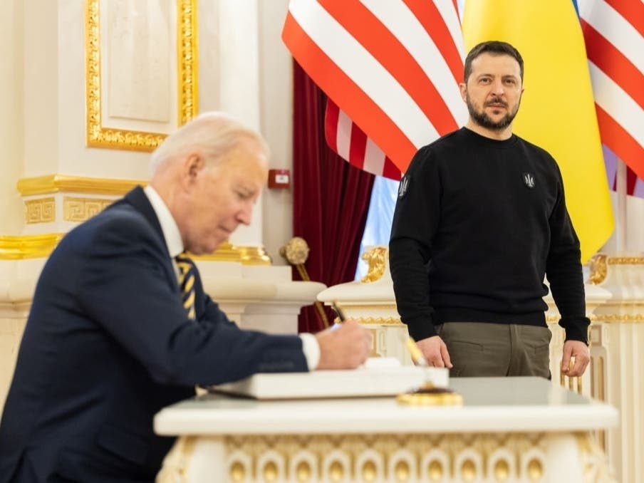 U.S. President Joe Biden signs the guest book during a meeting with Ukrainian President Volodymyr Zelenskyy at the Ukrainian presidential palace on February 20, 2023 in Kyiv, Ukraine.