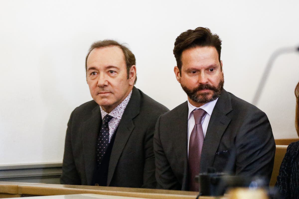 Kevin Spacey (left,) who showed up for his arraignment last year, wasn't in court Monday.