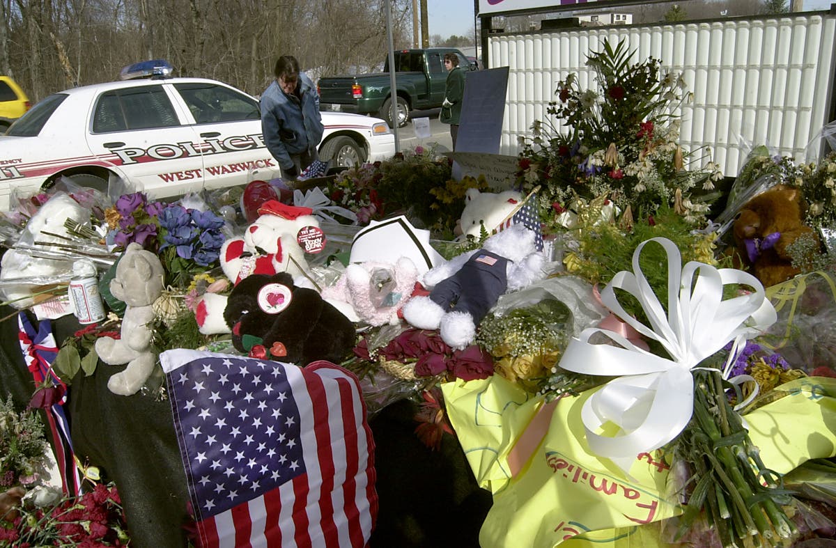 WEST WARWICK, RI - FEBRUARY 26: Mourners visit the makeshift memorial at the site of the deadly fire at The Station nigh