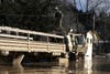 A National Guardsman stands on top of his vehicle in a flooded neighborhood on Feb. 28, 2019 in Guerneville, California