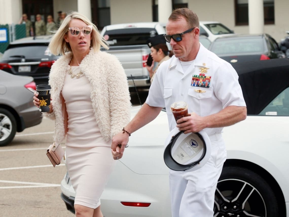 Navy Special Operations Chief Edward Gallagher, right, walks with his wife, Andrea Gallagher. 