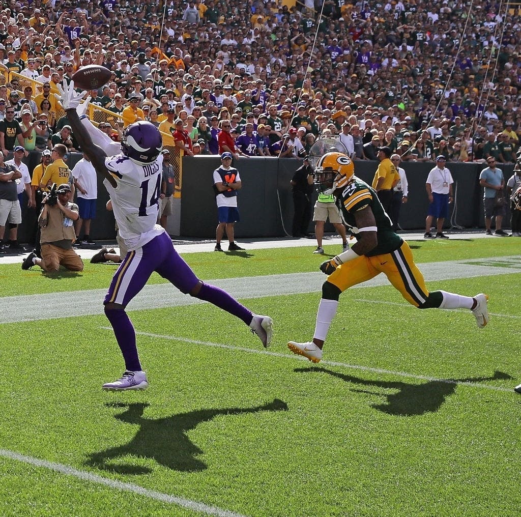 Stefon Diggs #14 of the Minnesota Vikings catches a pass for a two point conversion over Ha Ha Clinton-Dix #21 of the Green Bay Packers in 2018.