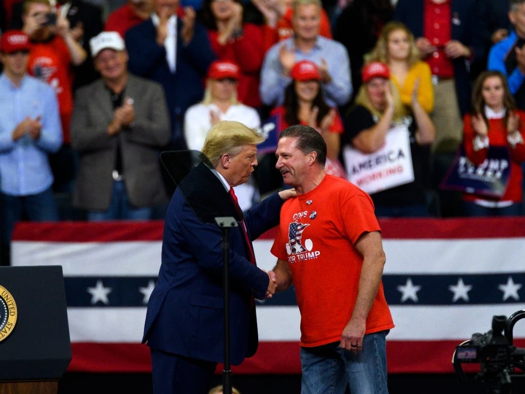 U.S. President Donald Trump shakes hands with Minneapolis Police Union head Bob Kroll on stage during a campaign rally at the Target Center on October 10, 2019 in Minneapolis, Minnesota. 